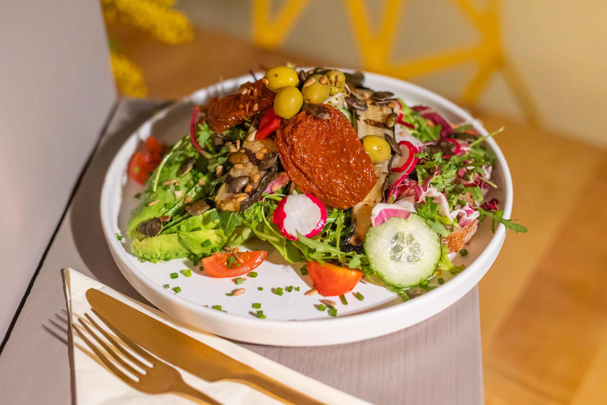 Vital Salat mit eingelegten Zucchini, getrockneten Tomaten, Oliven, Gurken, Kirschtomaten, Radieschen, gerösteten Kernen & gehobeltem Parmesan-Topping